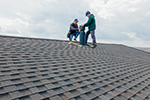 Chimney workers in Freehold on a grey tile roof