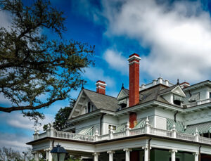 Freehold chimney service, 2 brick chimneys shown on large colonial style white home