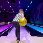 Boy bowling at an alley around homes for sale in Howell NJ